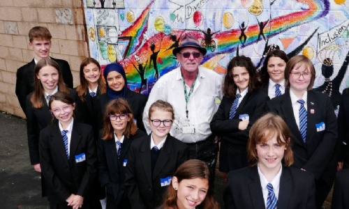 Picture of St James Students and Pete the Poet infront of the new diversity mural.