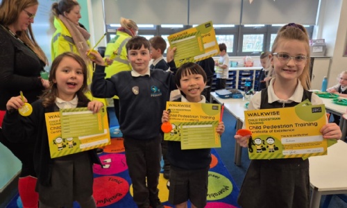Children from Marine Academy holding their Walkwise certificates 