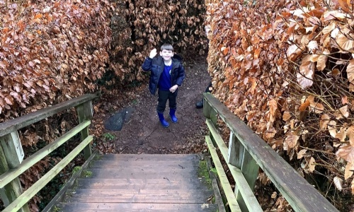 Whipton Barton Pupils Experience 'Living Saxon History' pupil outside with hand up