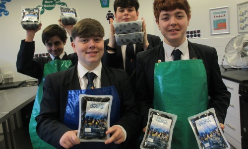 Marine Academy Plymouth students holding bags of  mussels 