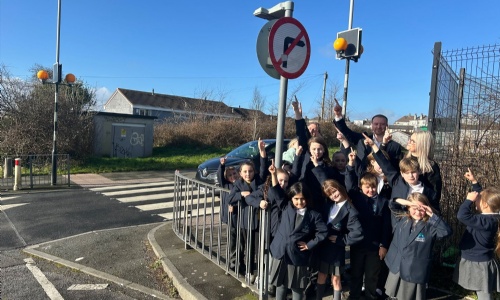 Marine Academy Primary pupils  out by the side of the road with MP Fred Thomas learning about road safety.