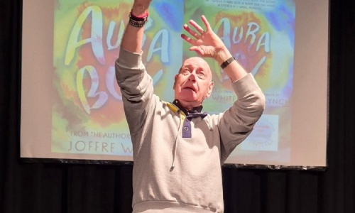 Author Joffre White on stage at Tor Bridge High