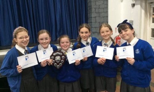 Students from Honiton Community College holding trophy and certificates from winning the Youth Speak Competition