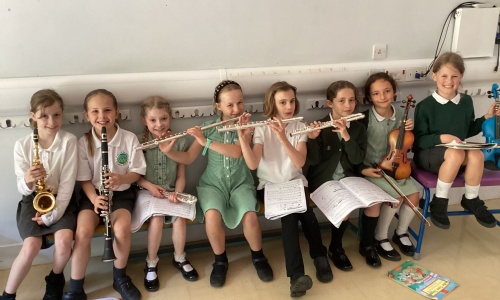 Exwick pupils sat with musical instruments 
