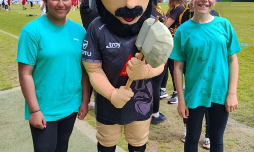 Children from Whipton Barton Federation stood with the Exeter Chiefs mascot at the ground. 
