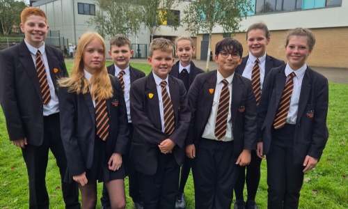 Students from Tor Bridge High stood outside part of the school building. 