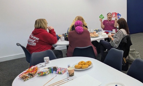 Burrington Community Hub new cafe the opening with people sat around a table  