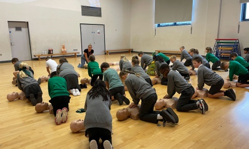Pupils practicing CPR in workshop
