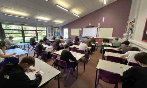 Sidmouth sixth formers sitting at desks taking the ukmt maths challenge