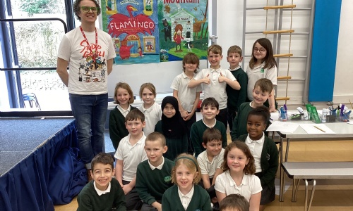 Alex Milway and a class at Exwick Heights pose for a photo