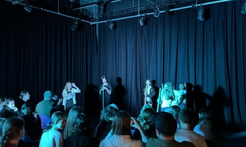 Students performing in front of an audience. 