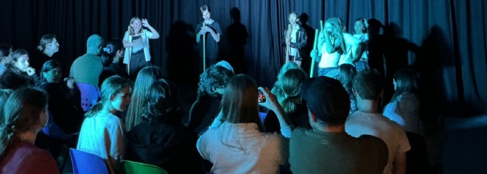 Students performing in front of an audience. 