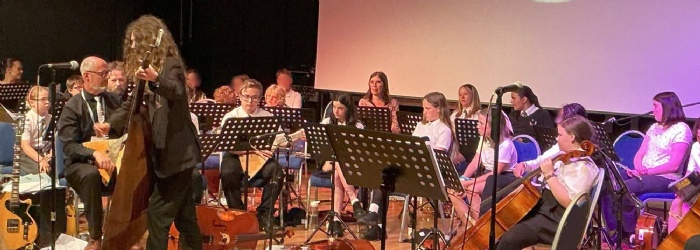 Students playing instruments on stage