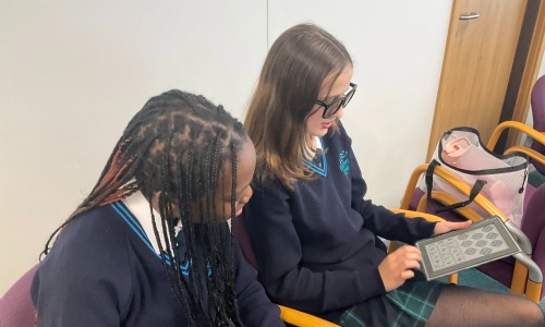 Students exploring vision testing equipment