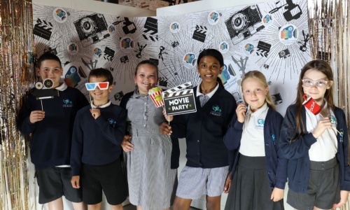 Students posing with props from the photo booth